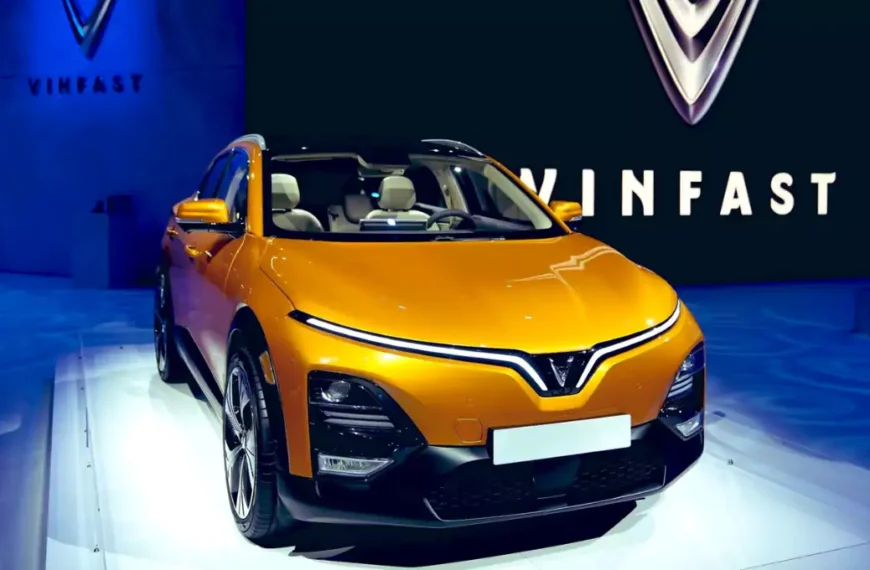 Golden VinFast VF 6 electric SUV displayed in a showroom